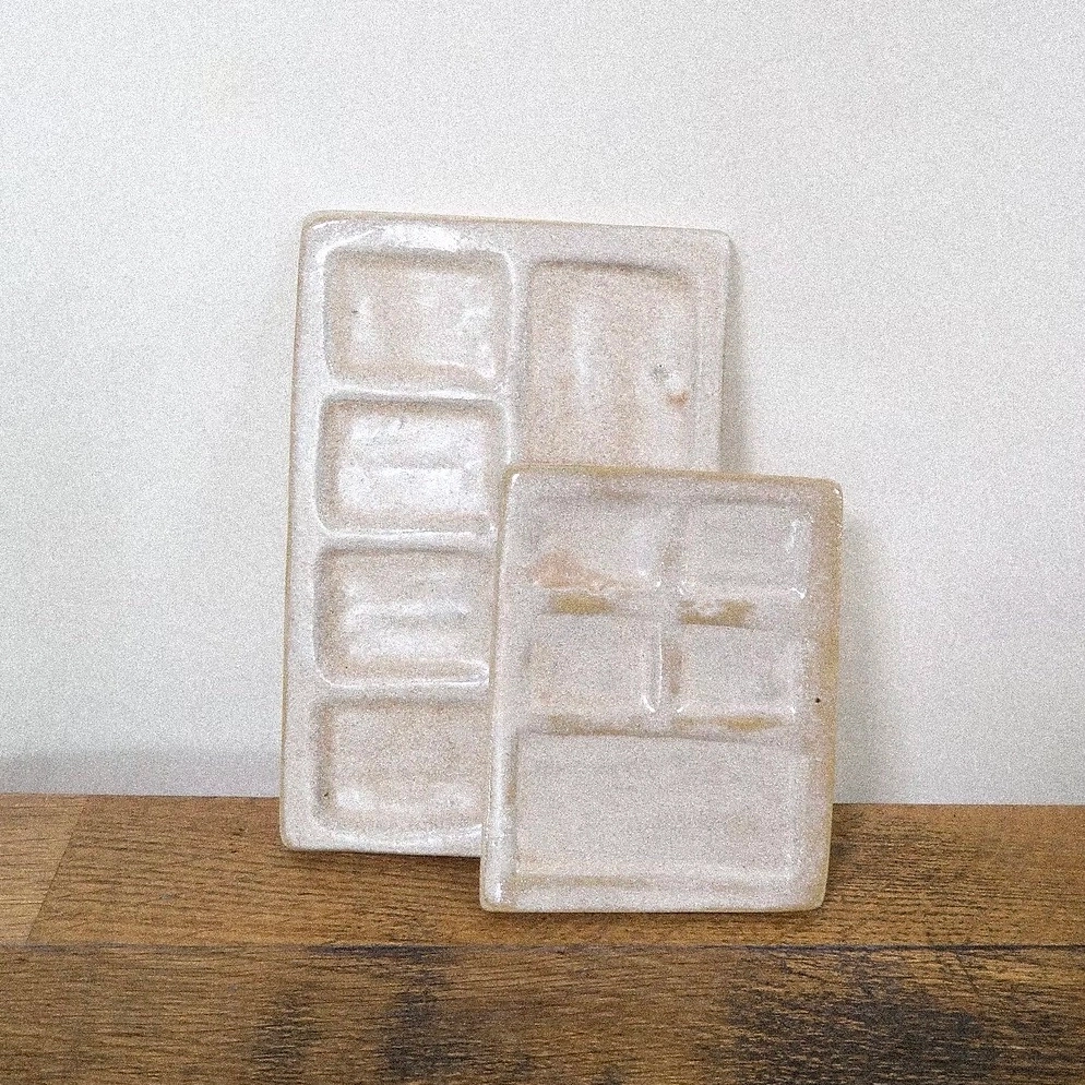 Pensées pour accompagner les moments de création, ces palettes de peinture sont modelées à la main dans mon atelier à Paris. Chaque pièce est unique, avec des courbes douces et organiques, conçues pour accueillir aquarelles, encres ou gouaches.
La version petite est idéale pour les formats nomades, tandis que la grande offre plus d’espace pour jouer avec les nuances et les mélanges.
Leur surface émaillée permet un nettoyage facile tout en mettant en valeur les pigments.
Comme chaque pièce est façonnée à la main, formes, tailles et textures peuvent varier légèrement, ce sont ces petites différences qui font leur singularité.
DIMENSIONS :
S: L 8cm, H 10cm environ
M: L 10cm, H 14,5cm environ